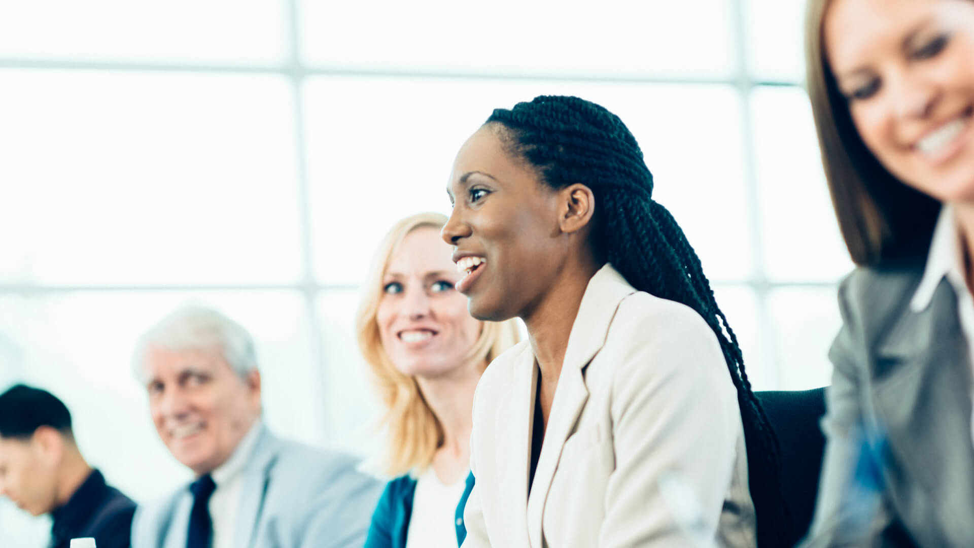 Diverse group of professionals smiling in a meeting.