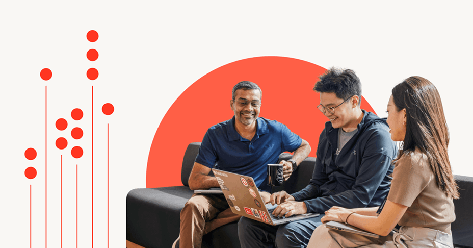Three people smiling, working on laptops.