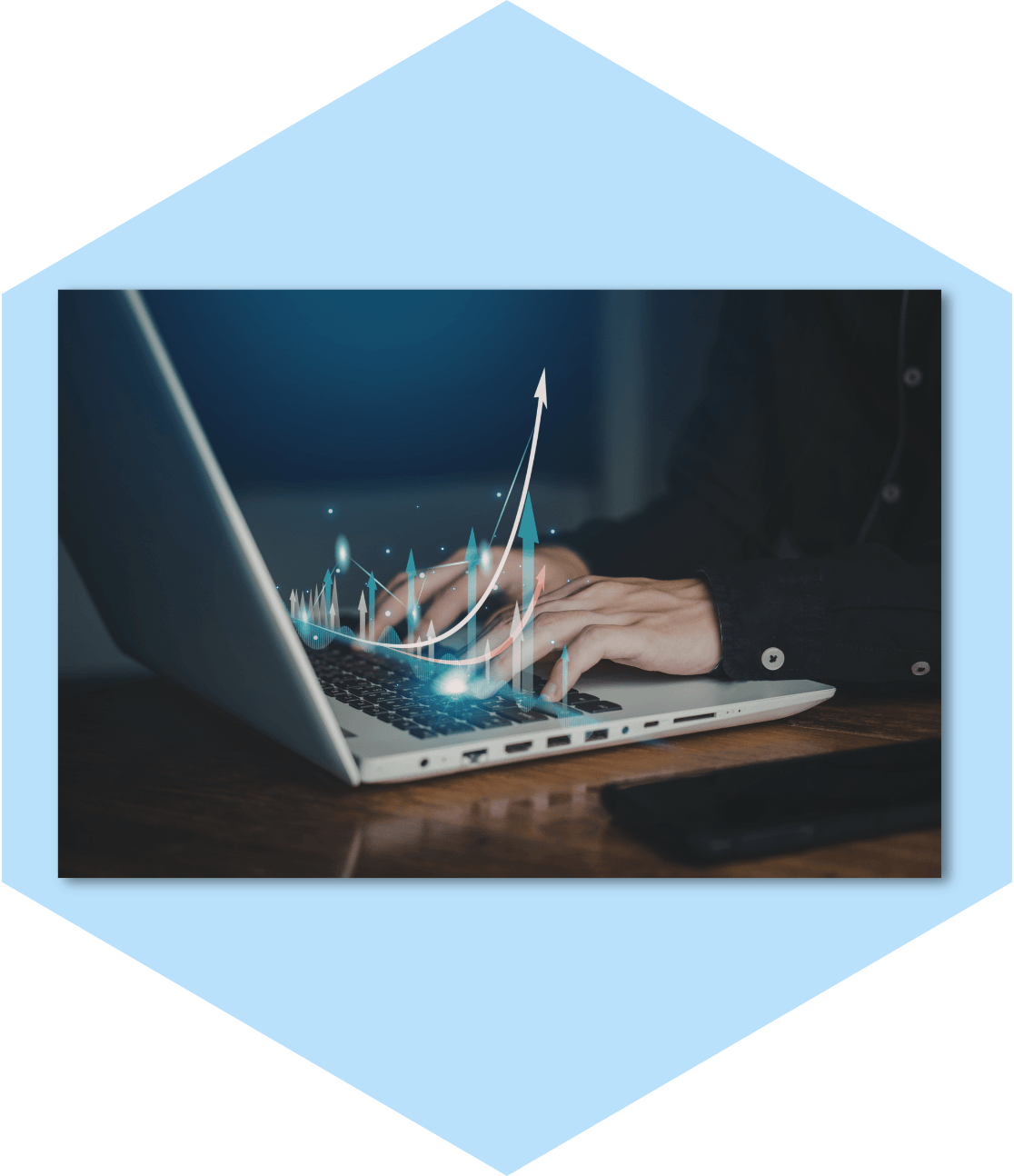 Hands on laptop with glowing upward trend arrows.