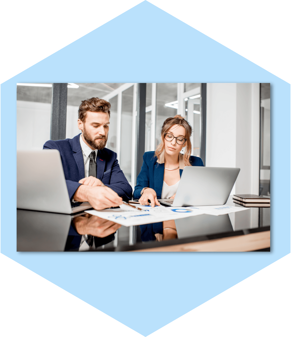 Business colleagues discussing data at a desk.
