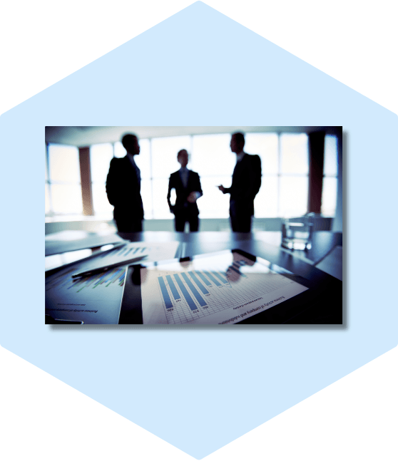Businessmen discuss over charts and graphs.