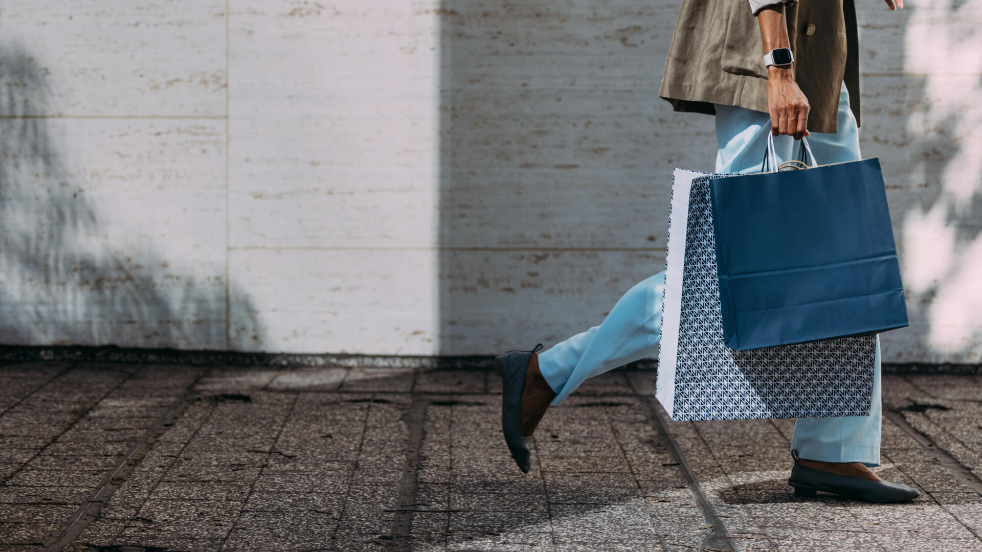 Person walking with multiple shopping bags.