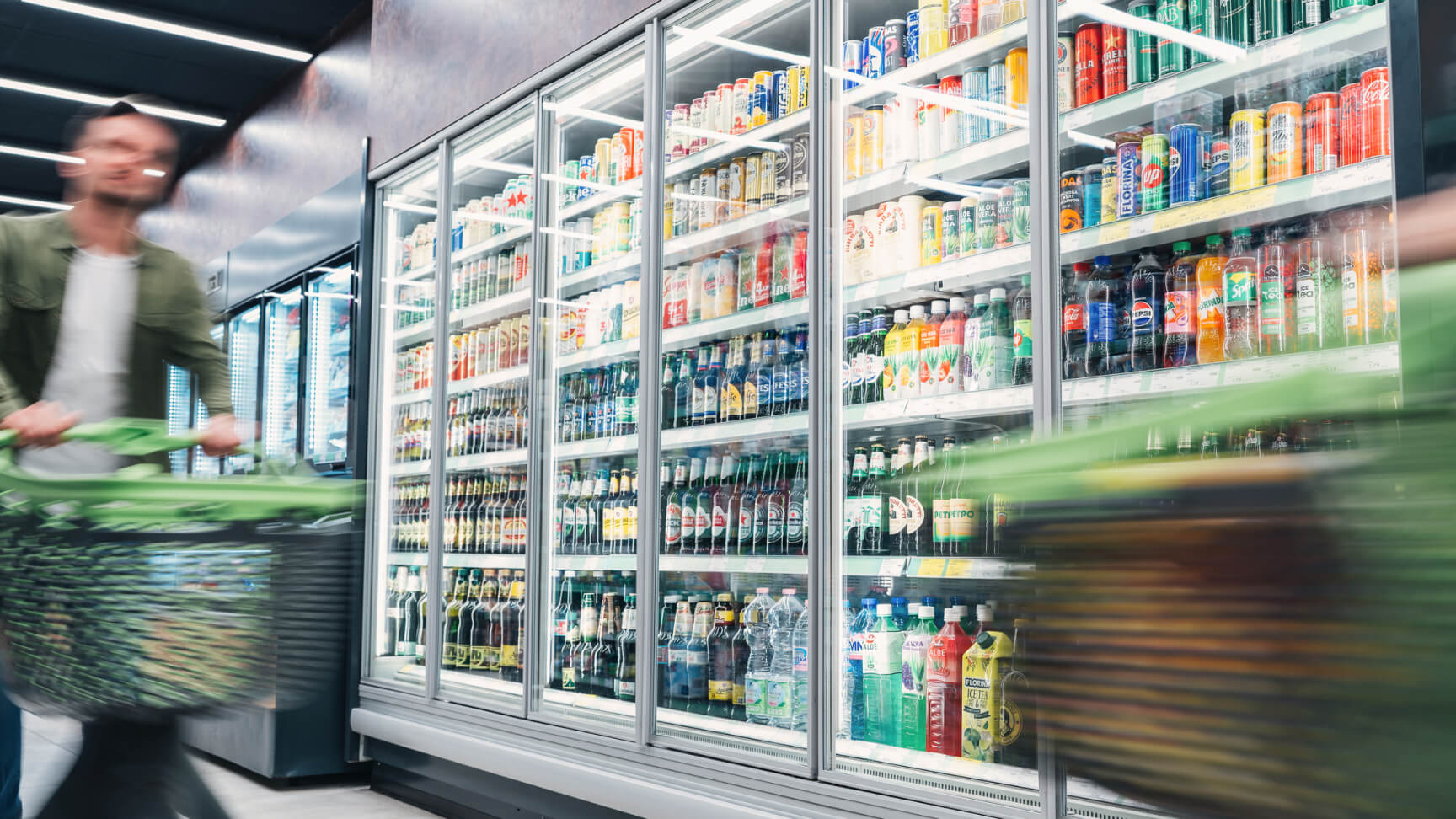 Blurred person shopping in beverage aisle